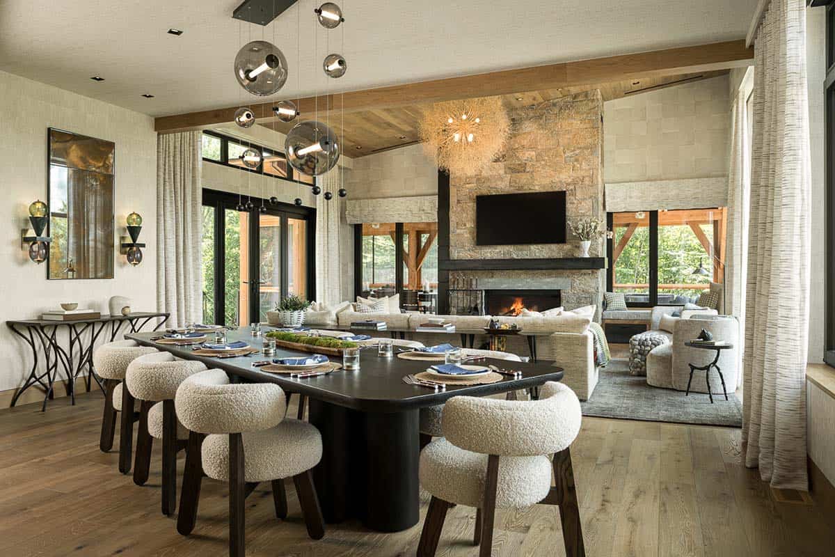 Dining table with boucle chairs and glass globe chandelier open to great room