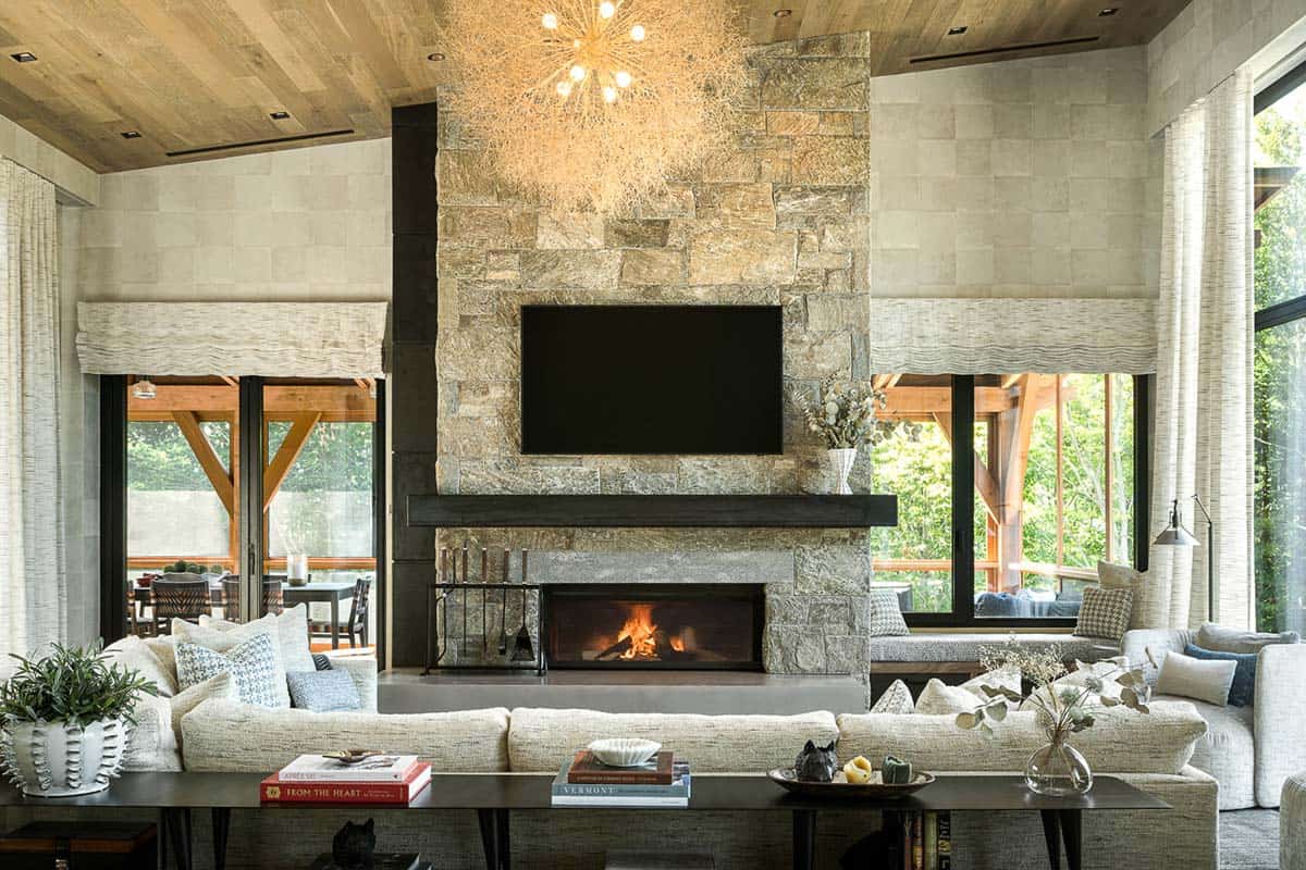 Great room with stone fireplace, wood ceiling, and white sectional