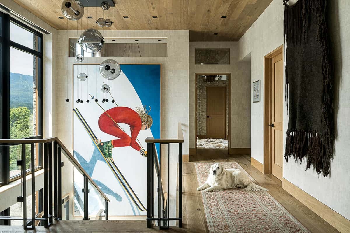 Upstairs landing with skier painting, glass globe pendant, and runner rug