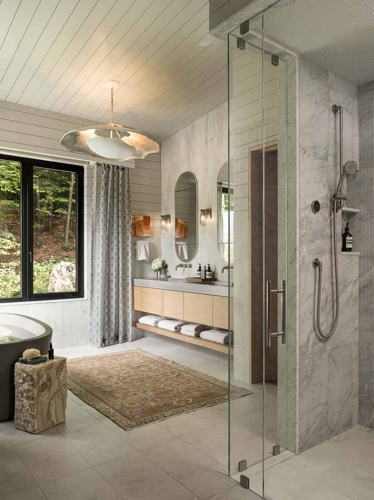 Primary bathroom with floating oak vanity and glass marble shower