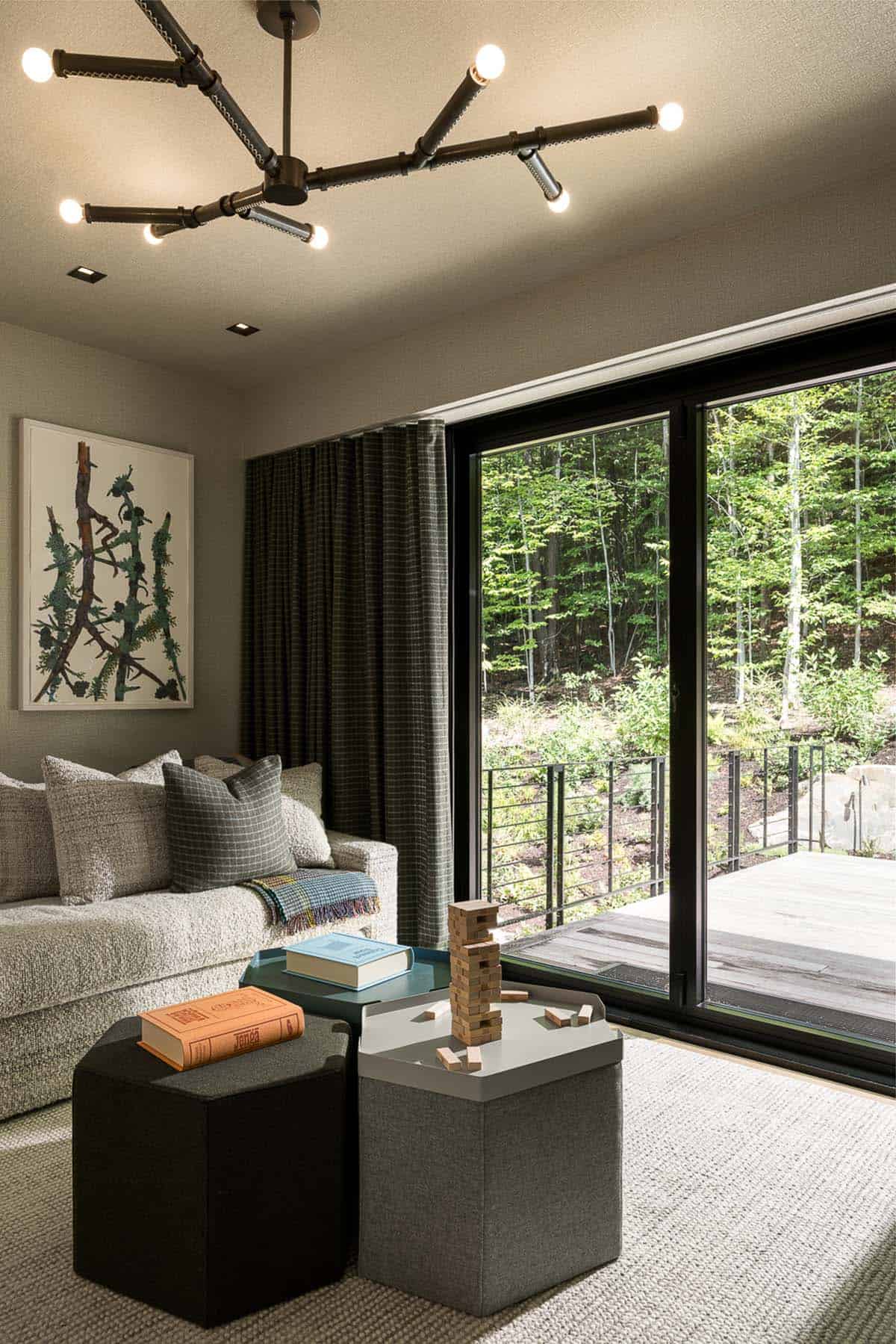 Family room with daybed, hexagon ottomans, and sliding doors to deck
