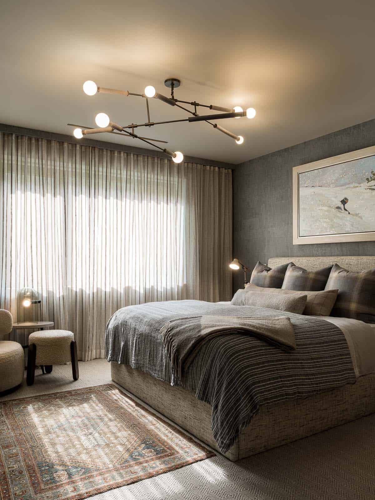 Guest bedroom with sculptural ceiling light and ski landscape painting