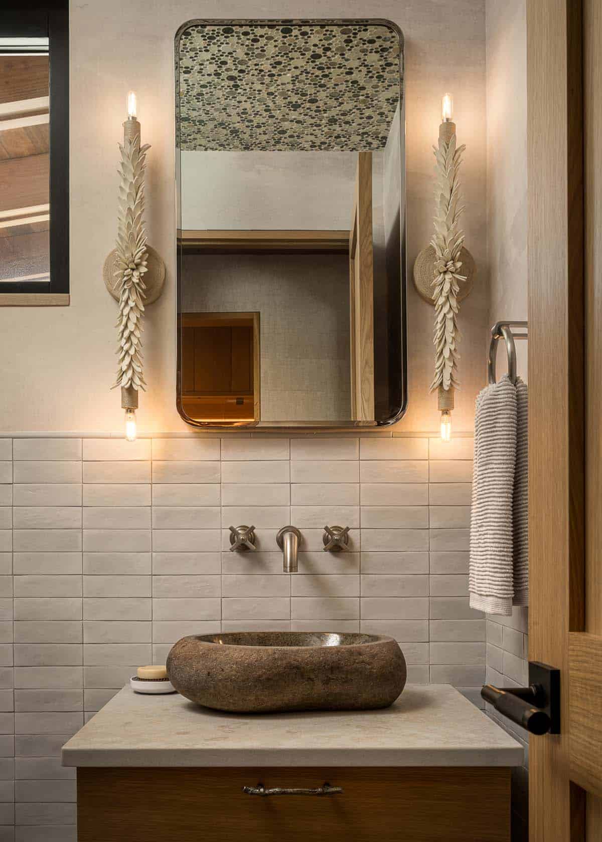 Powder room with stone vessel sink and ceramic petal sconces