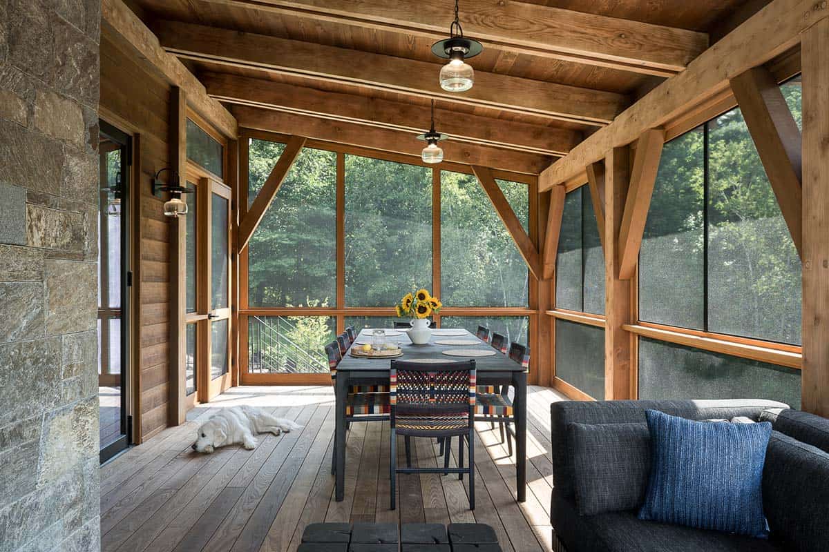 Screened porch dining table with timber framing and golden retriever