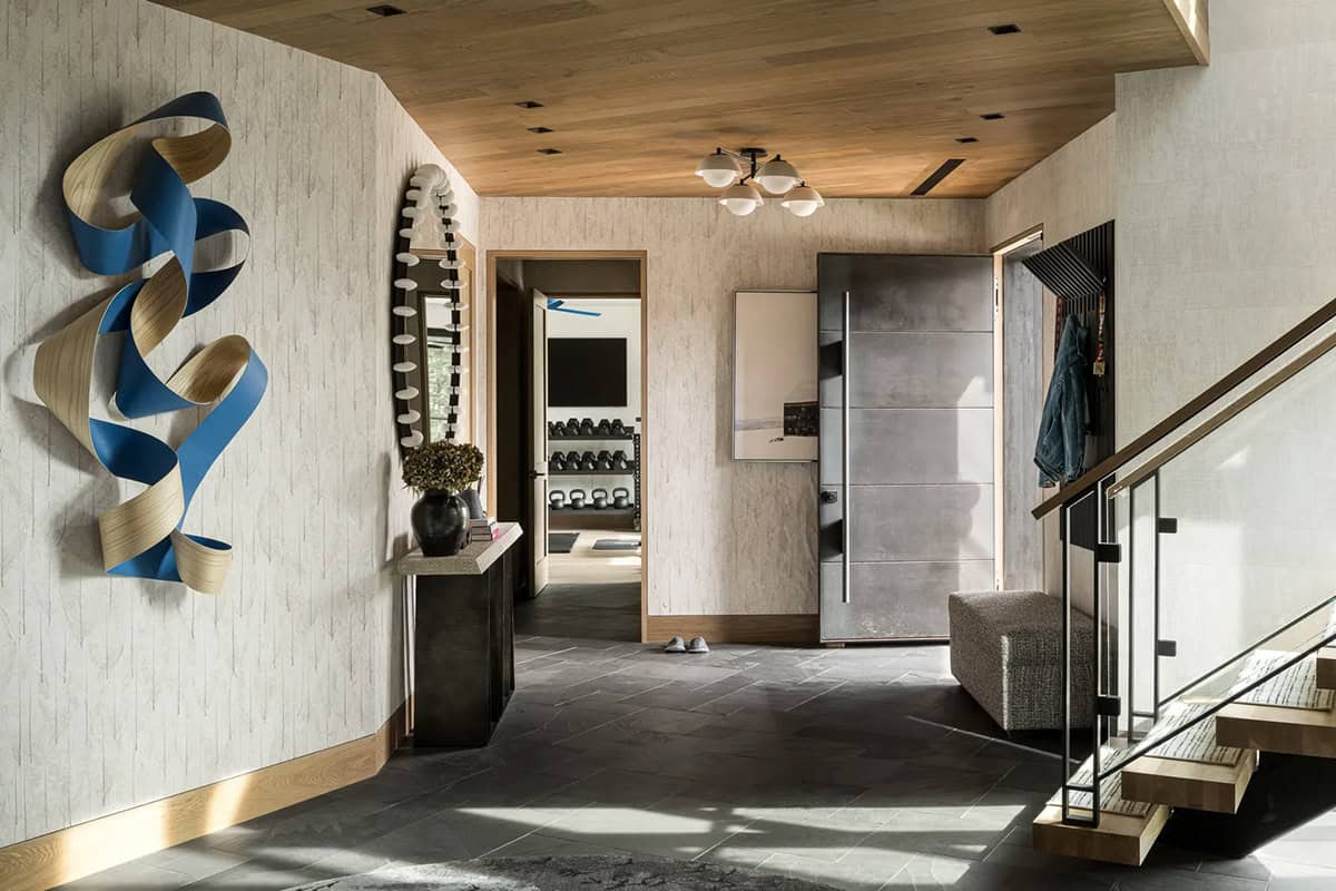 Entry foyer with blue ribbon wall sculpture and steel front door
