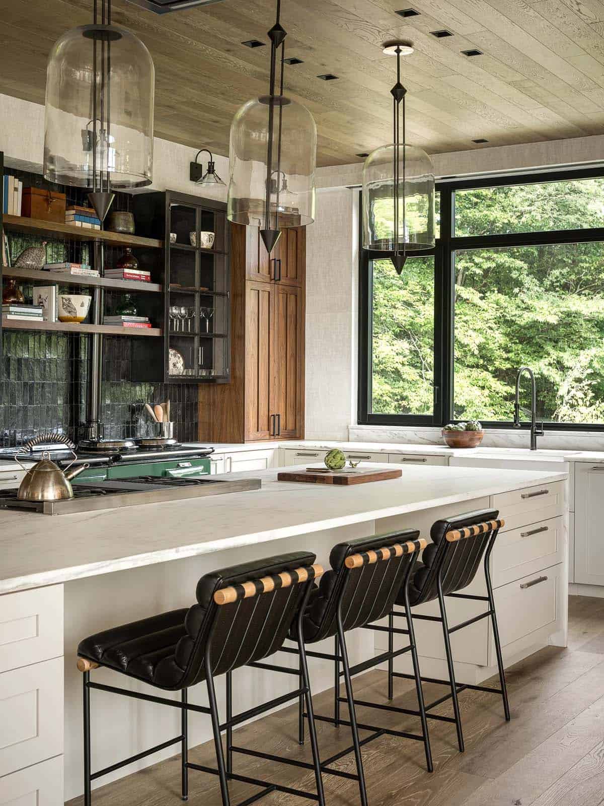 Kitchen island with leather stools and glass bell pendants