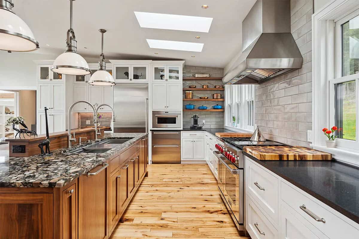 Kitchen with a walnut island and double sink, professional range under a stainless hood, and open shelves with copper pots