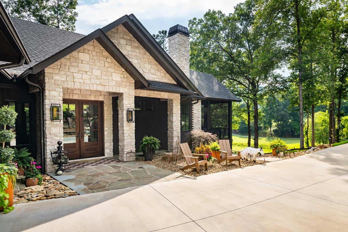 Front entry with stone gables, wood double doors and Adirondack chairs