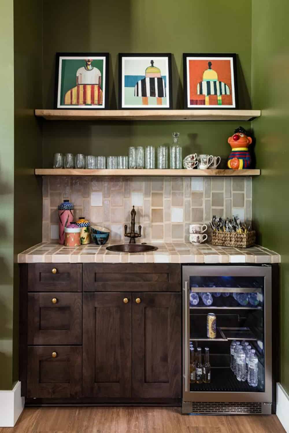 Wet bar with olive walls, tile countertop, copper sink and wood shelves