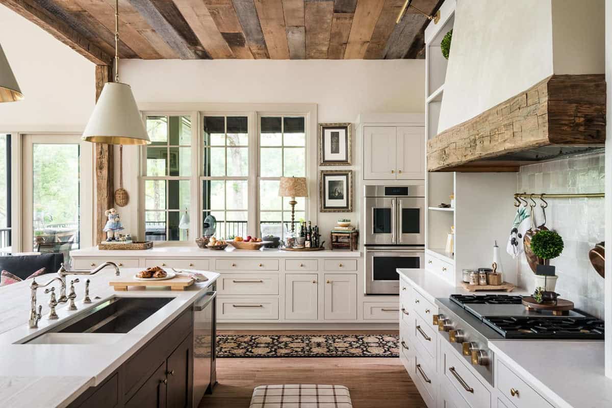 Kitchen with brass pendant, French door wall ovens and window over counter