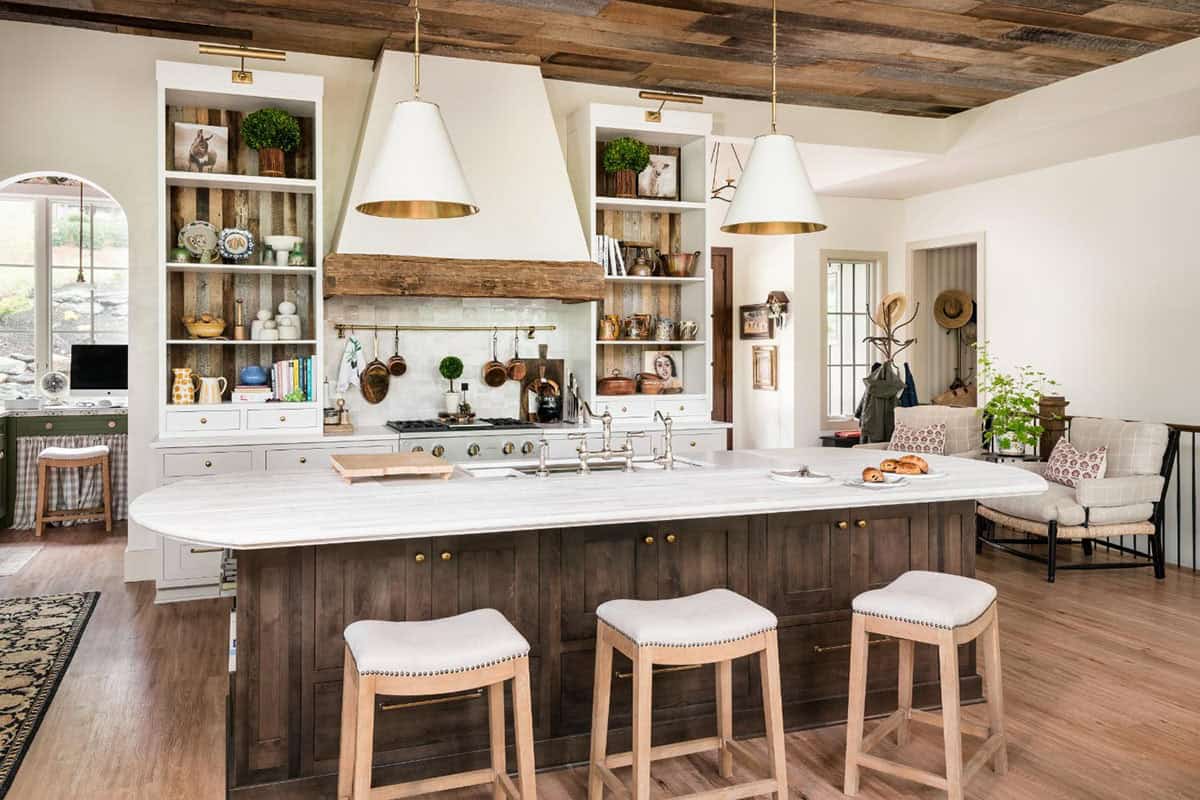 Kitchen island with whitewashed wood top and upholstered stools