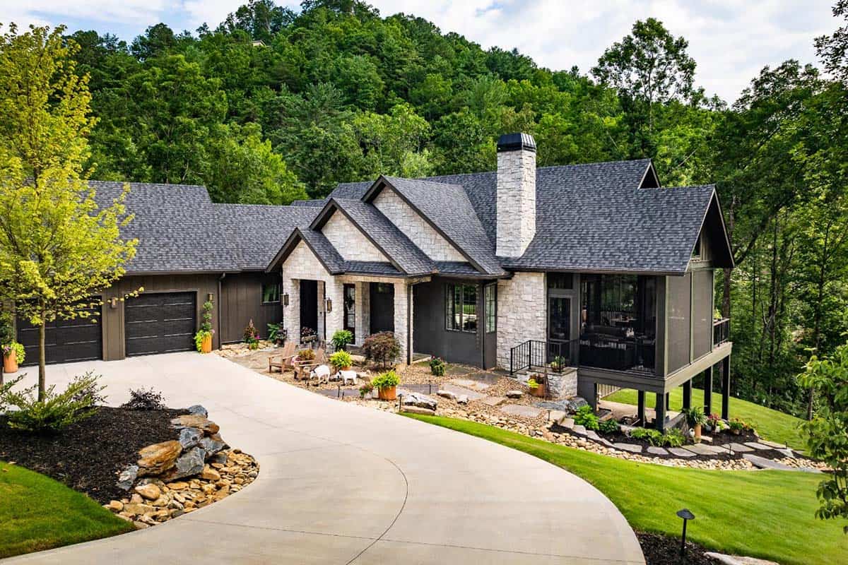 Stone and board-and-batten home exterior with curved driveway and garage