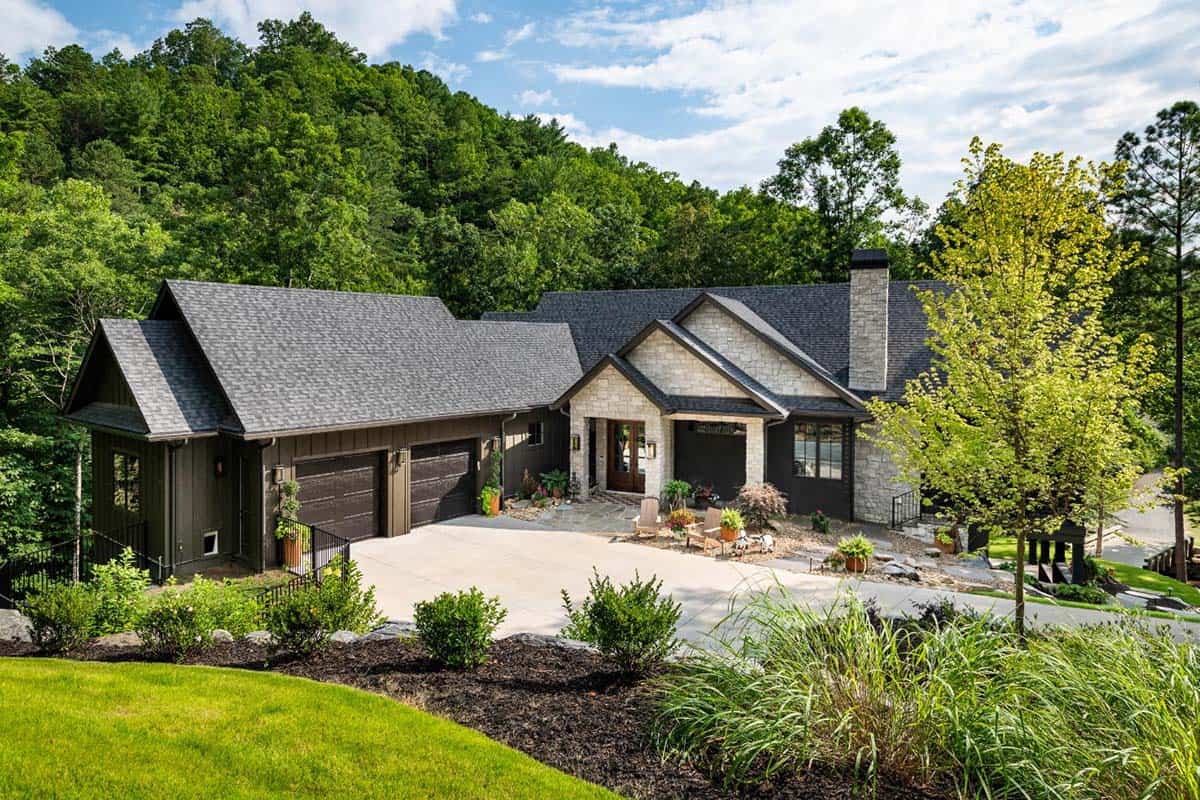 Home exterior with two-car garage, stone entry and ornamental grasses