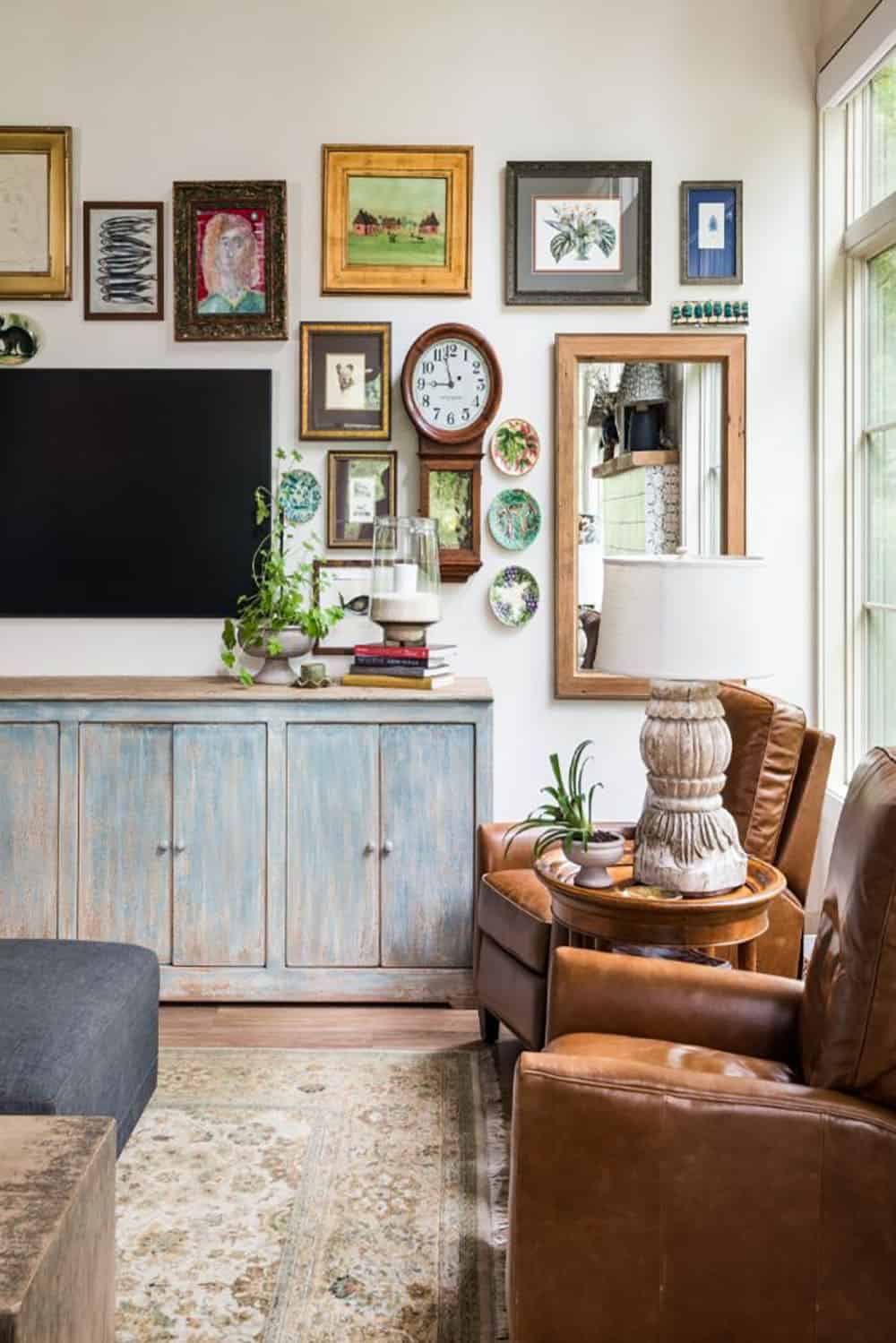 Gallery wall with vintage clock and decorative plates above a painted console