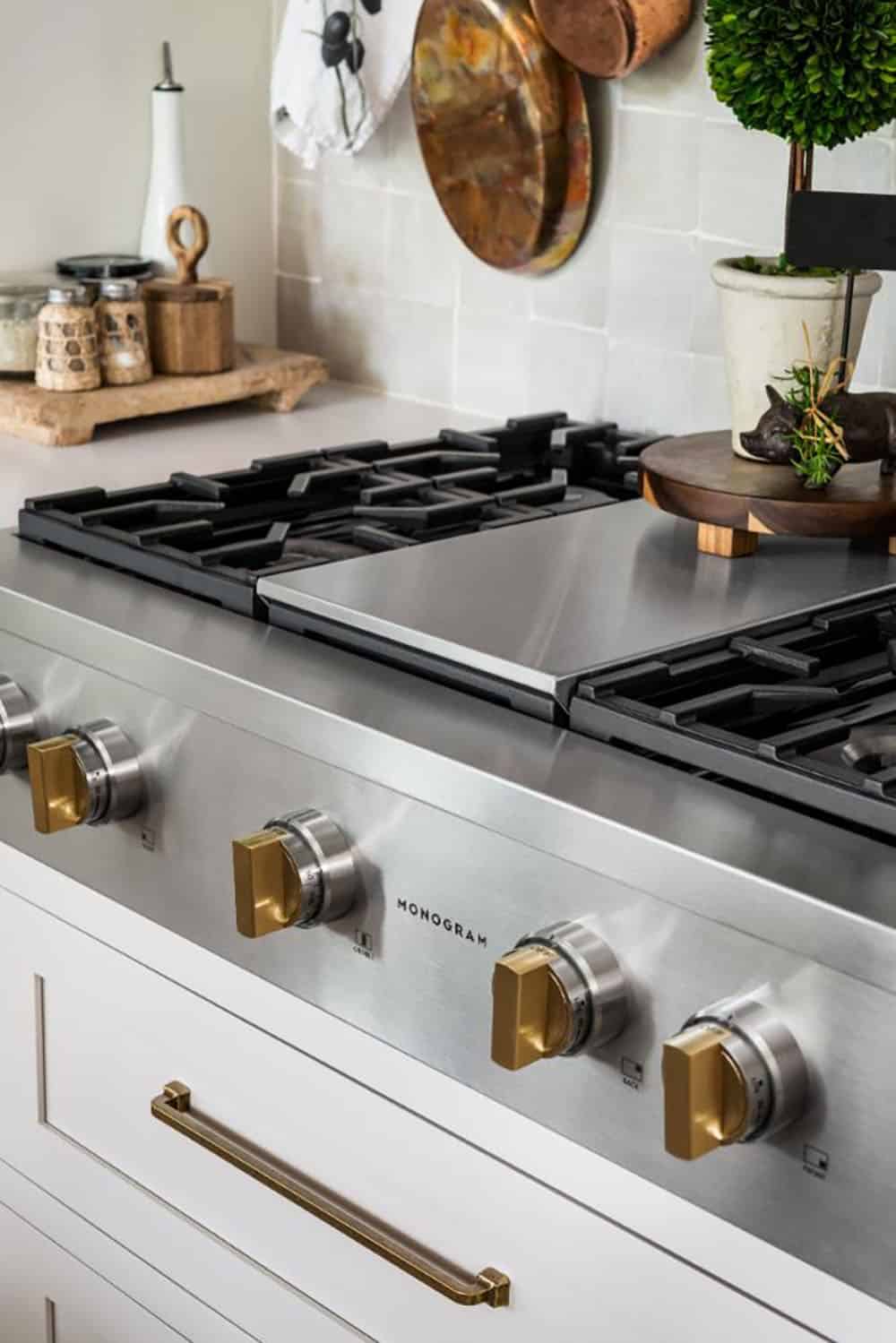 Stainless steel rangetop with brass knobs and griddle