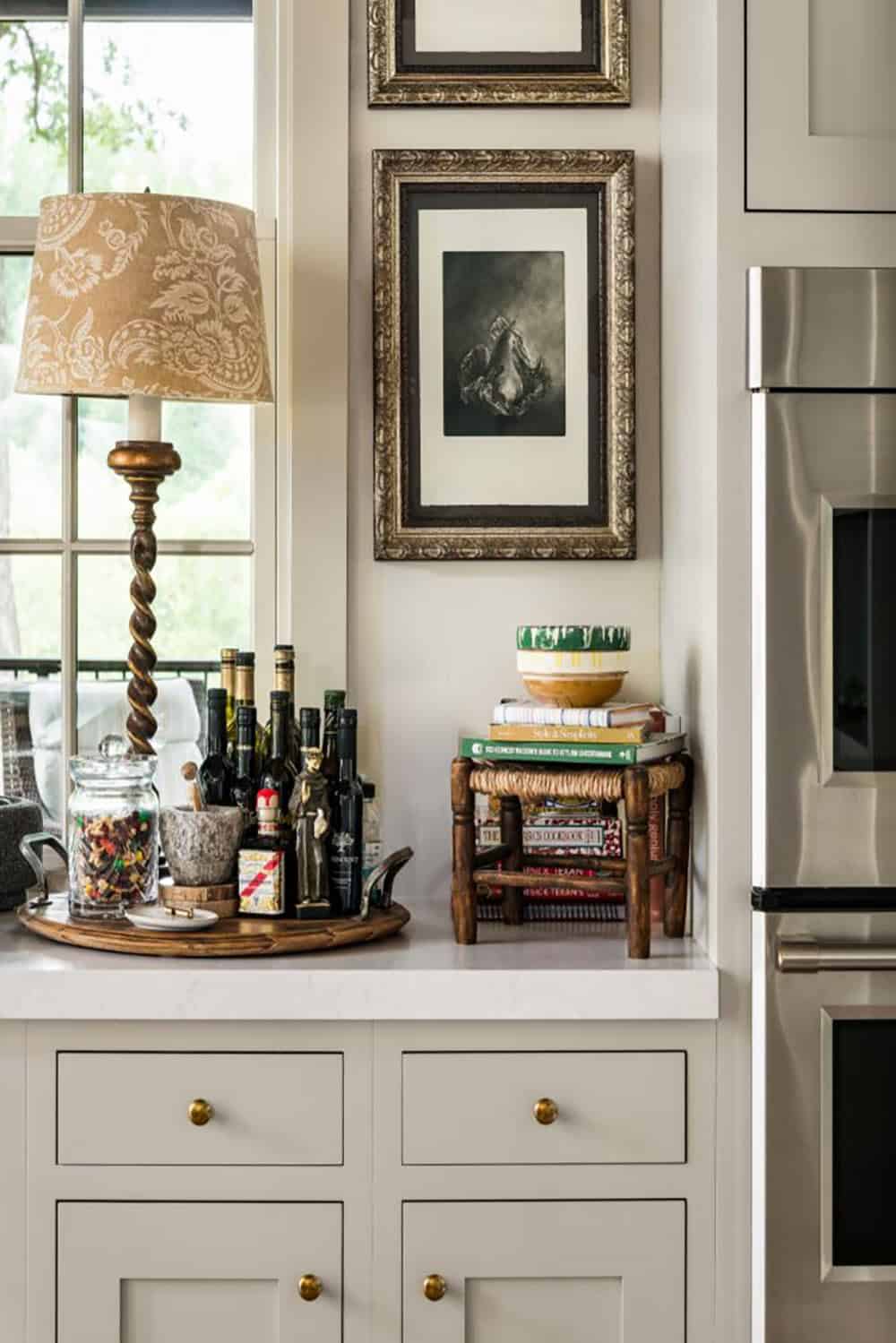 Kitchen counter with barley twist lamp, oil bottles and framed still life
