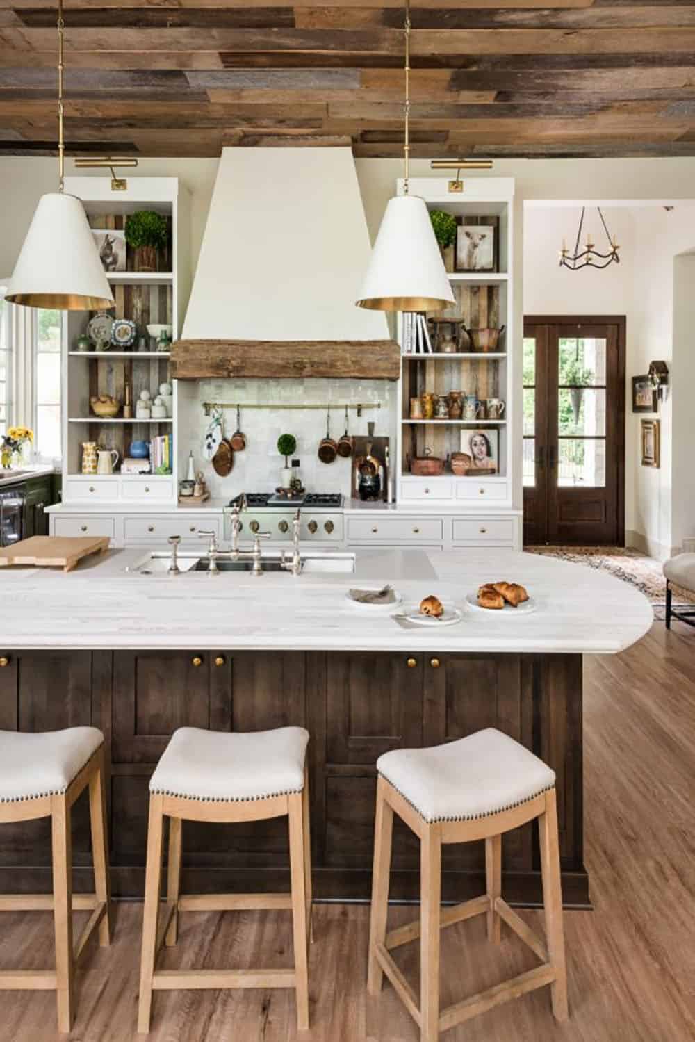 Kitchen island and range wall with view to wood front doors