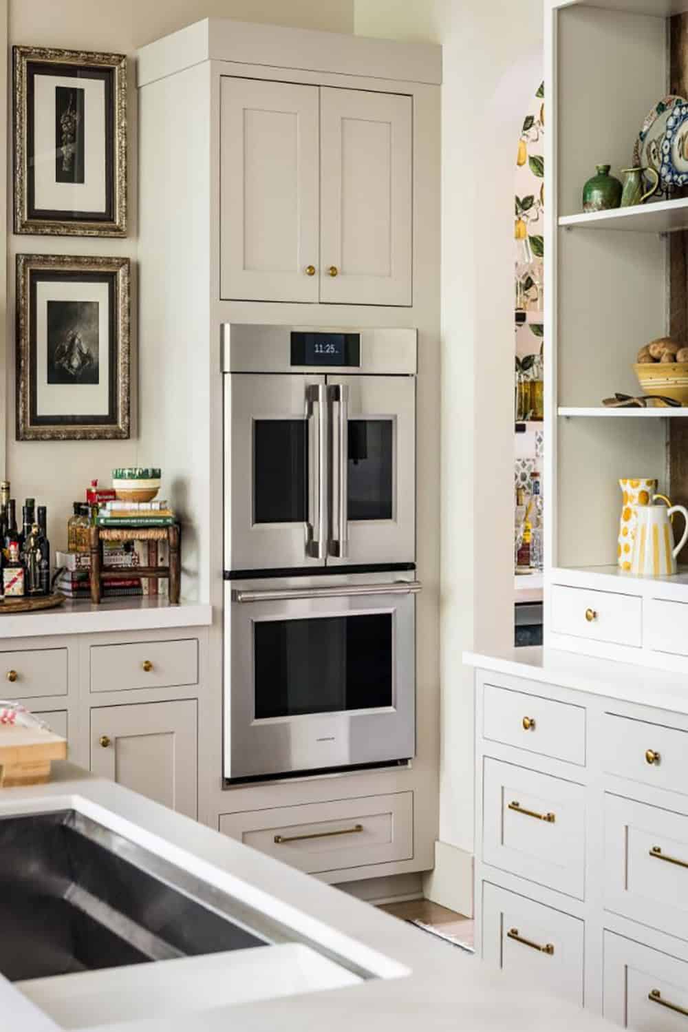Stainless French door wall ovens in greige cabinetry