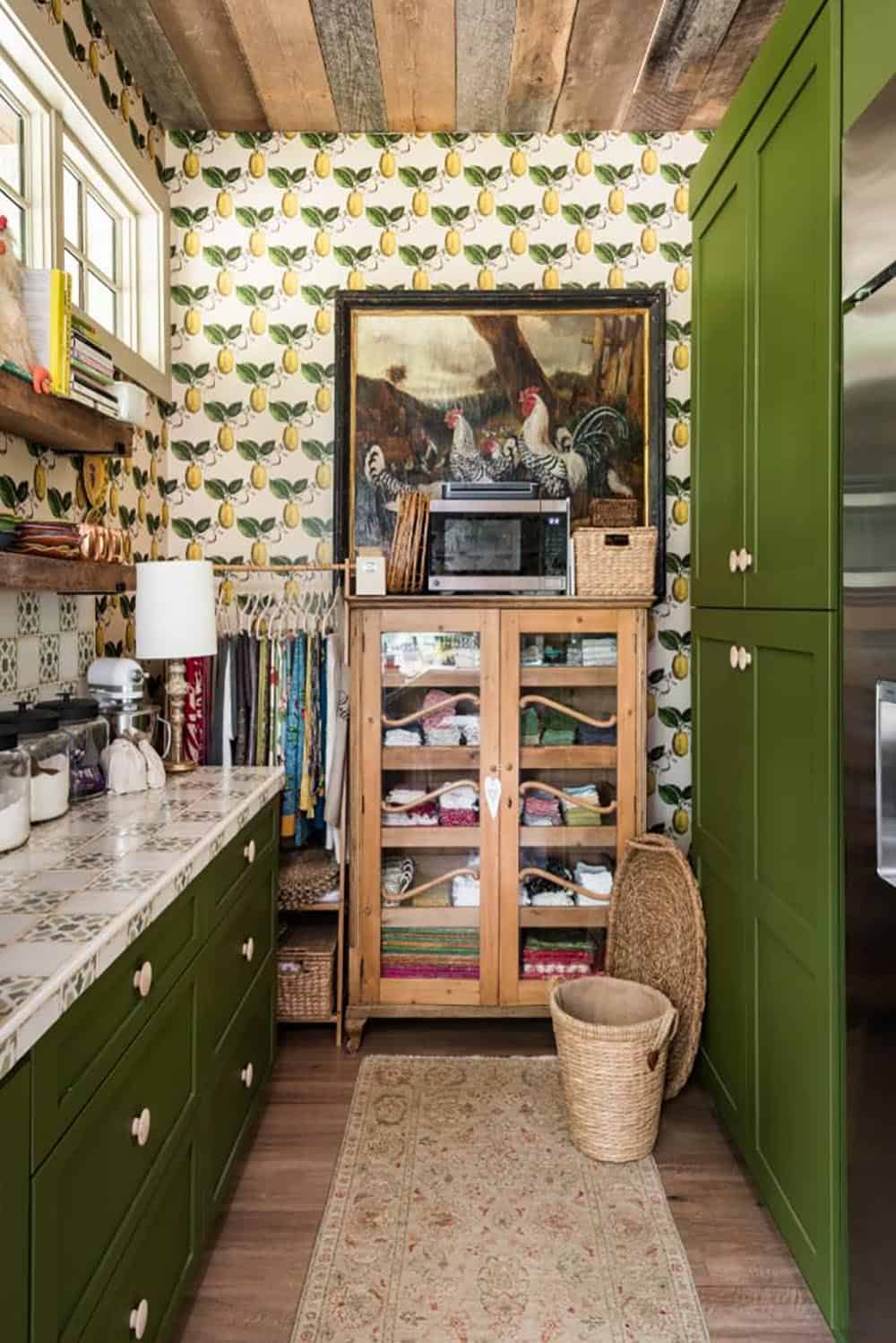 Butler’s pantry with green cabinets, lemon wallpaper and pine linen cabinet