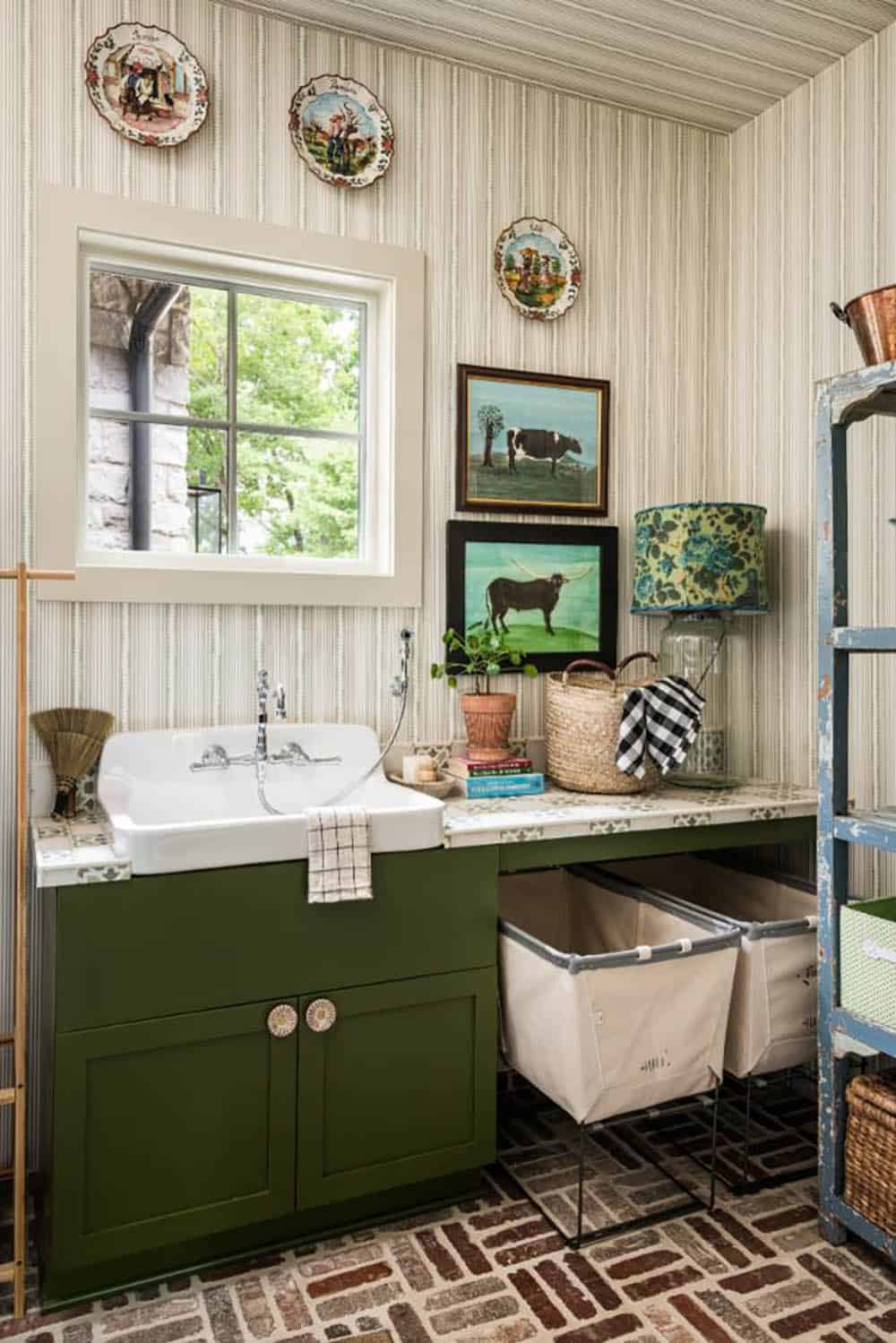 Laundry room with green cabinet, farmhouse sink and herringbone brick floor