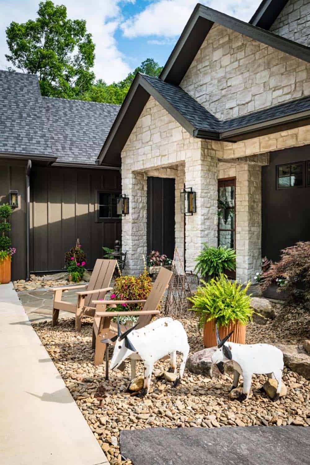 Front courtyard with Adirondack chairs and white goat sculptures
