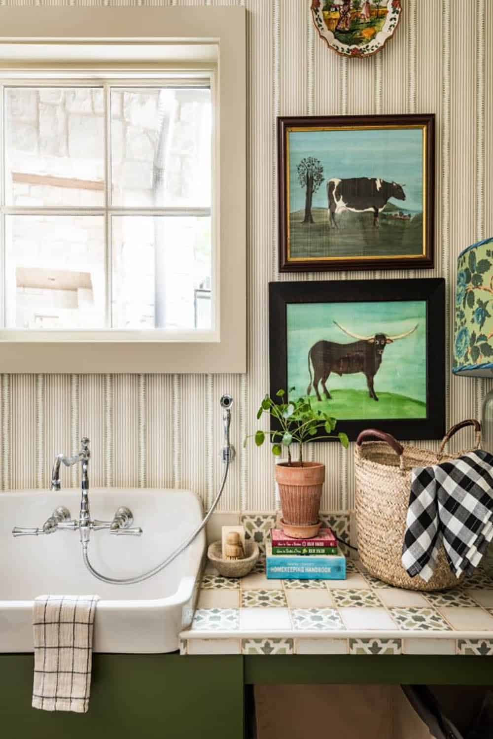 Laundry sink with wall-mounted faucet and folk art cow paintings