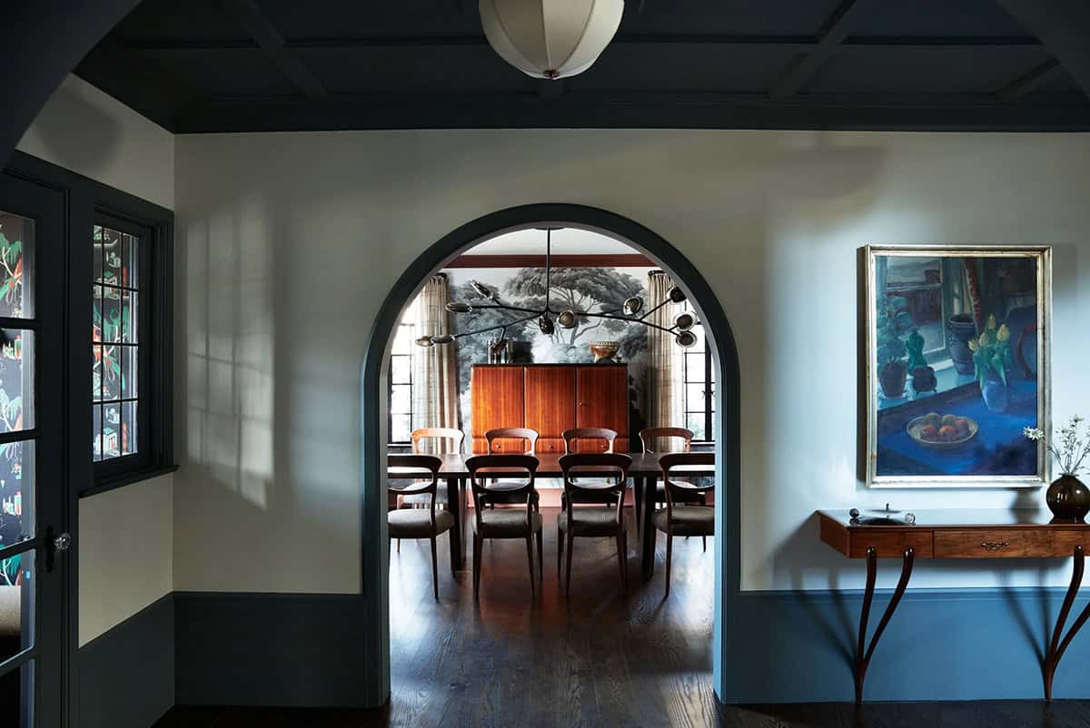 Front hall arched doorway looking into dining room with tree mural
