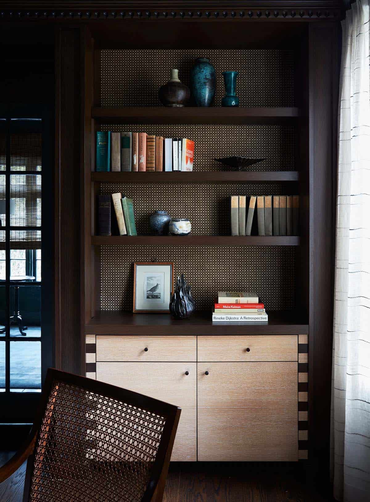 Built-in bookshelves with woven backing and cerused oak lower cabinets