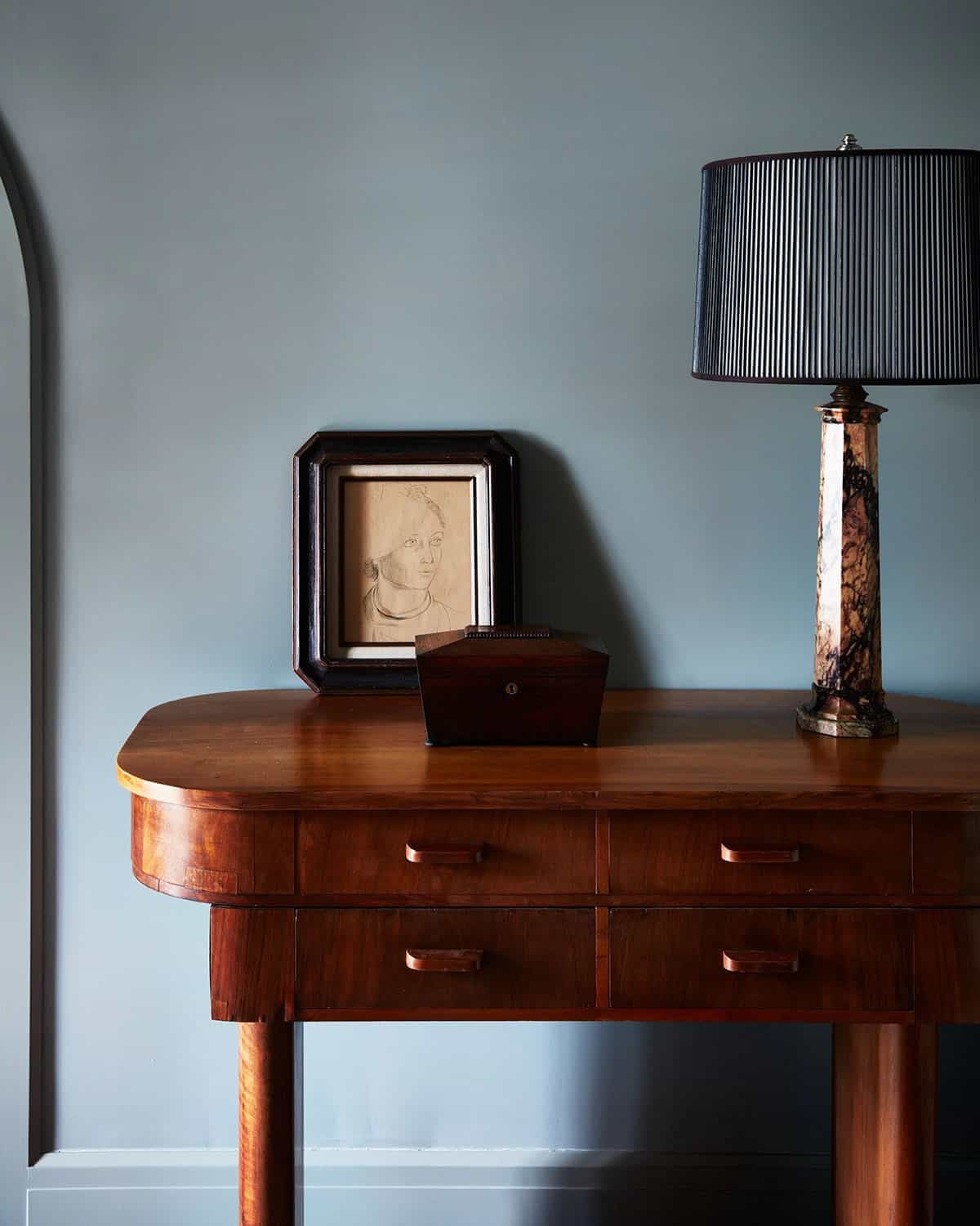 Walnut console with marble lamp, wooden box and framed portrait drawing