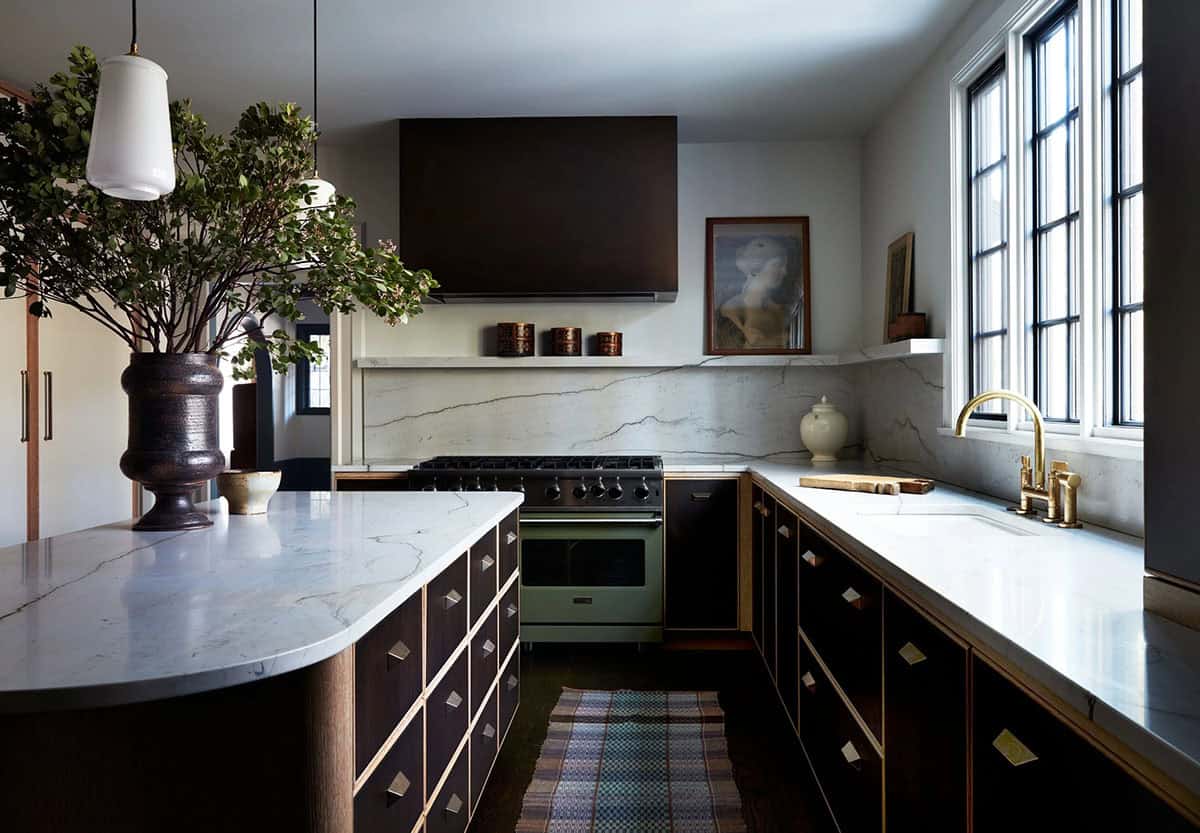Kitchen with dark wood cabinets, quartzite backsplash and sage green range