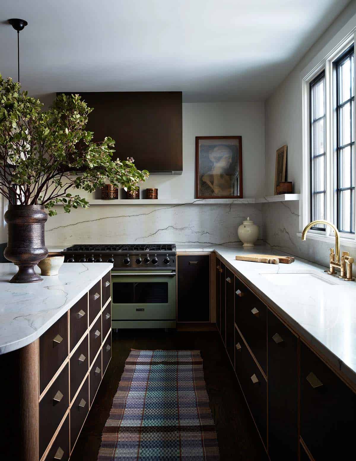 Kitchen with curved island, brass faucet and plaid runner