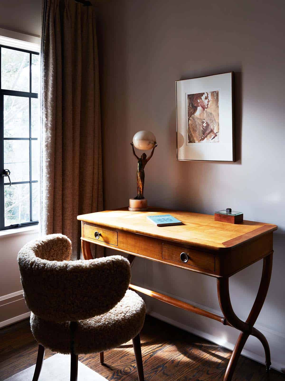 Bedroom writing desk with figural alabaster lamp and shearling chair