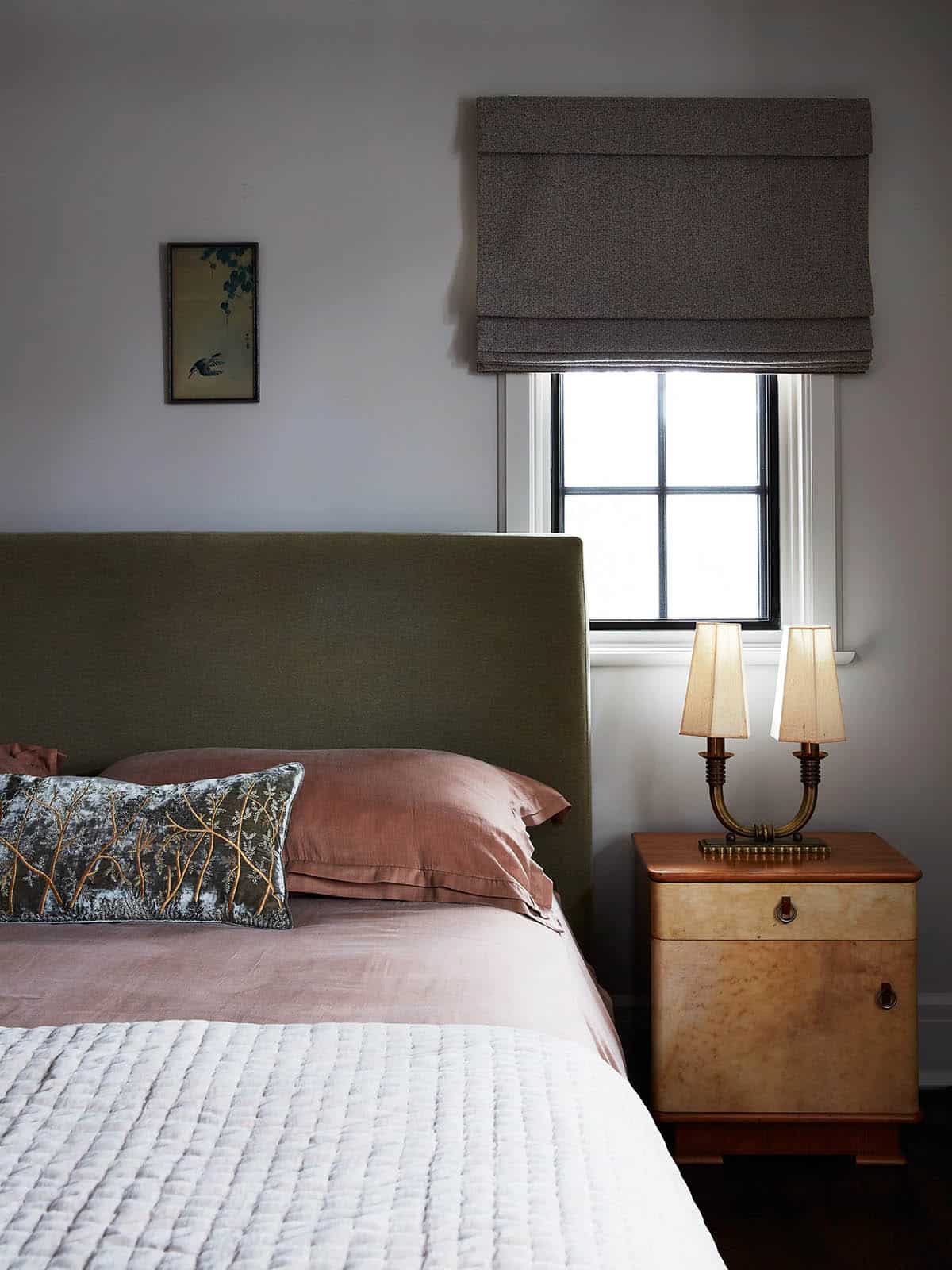 Bedroom with olive headboard, birch nightstand and brass twin lamp